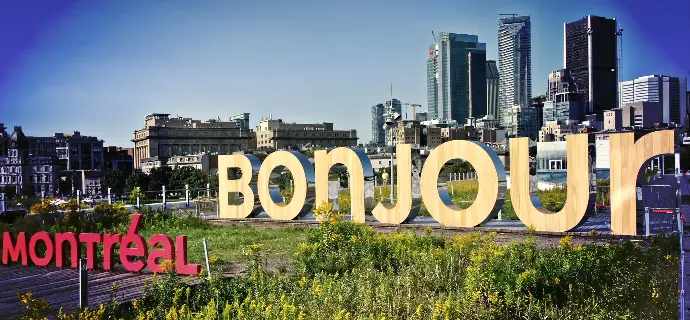 A sign that says bonjou in front of a city